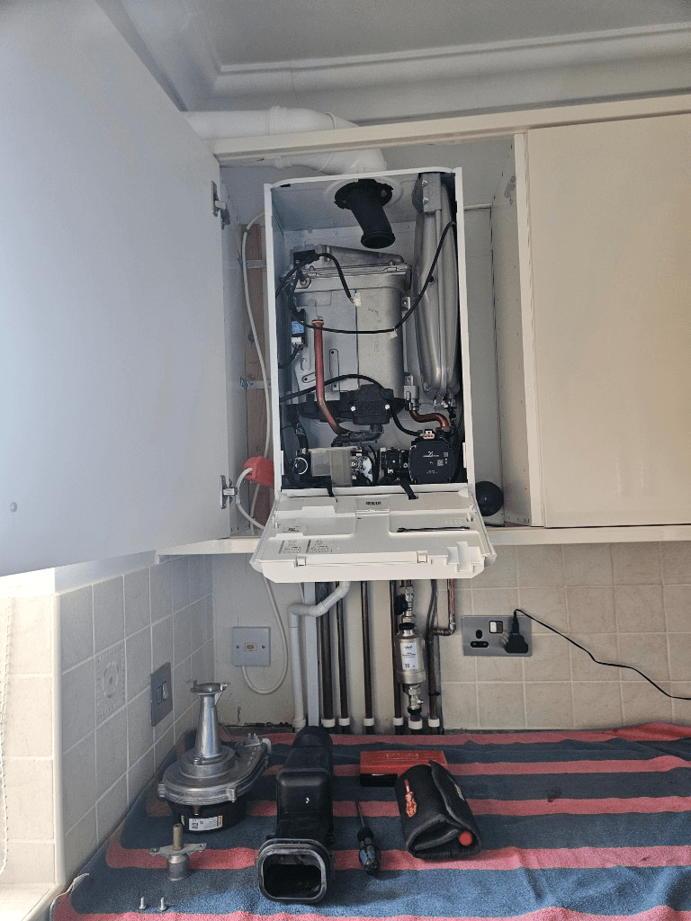 Open boiler casing during a thorough professional boiler service by Bay Plumbing & Heating